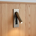 brushed copper recessed adjustable bedroom reading light mounted on a wooden headboard