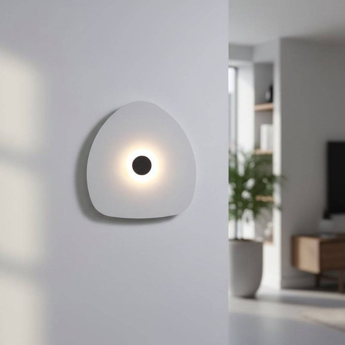 Modern internal wall light white finish with a black halo dot to the centre in a modern home setting