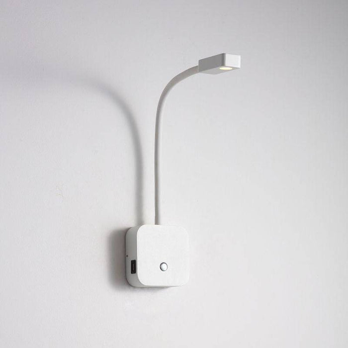 white bedroom reading lamp with USB ports installed on a white wall