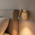 chrome adjustable wooden reading light mounted next to a bed