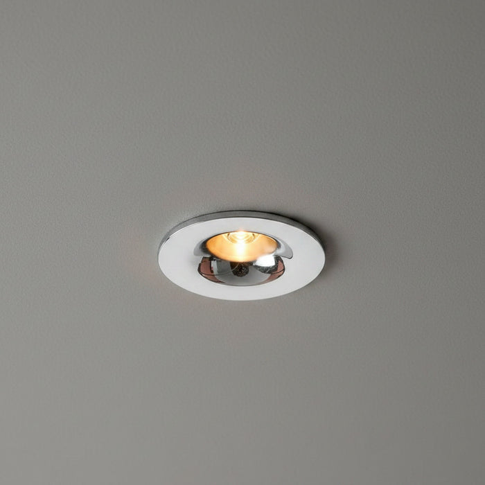 chrome flush recessed downlight mounted in a grey ceiling