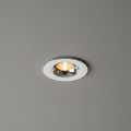 chrome flush recessed downlight mounted in a grey ceiling