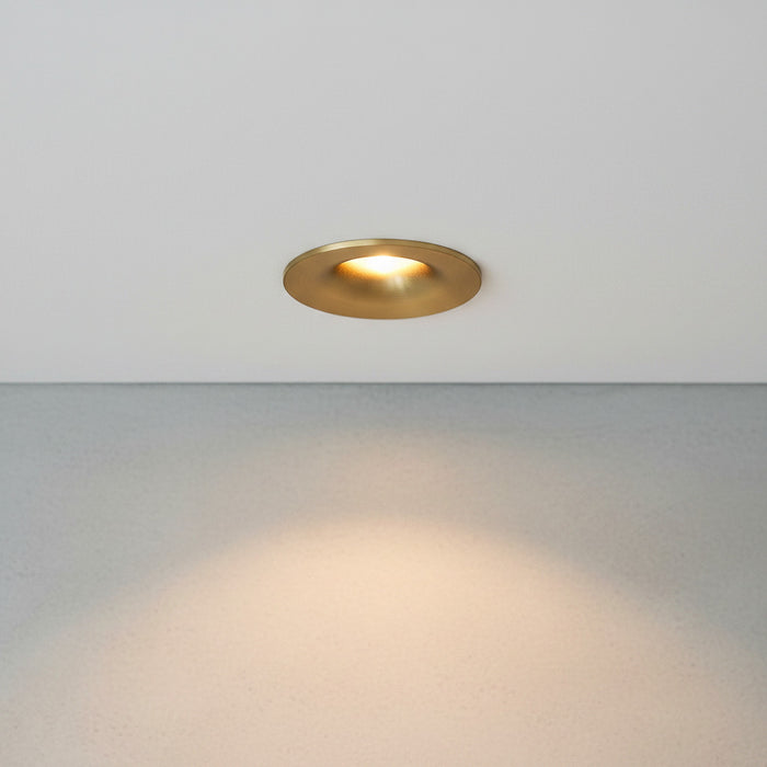 gold small ceiling spotlight recessed into the ceiling in a modern home