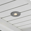 grey small soffit light mounted in a white house soffit