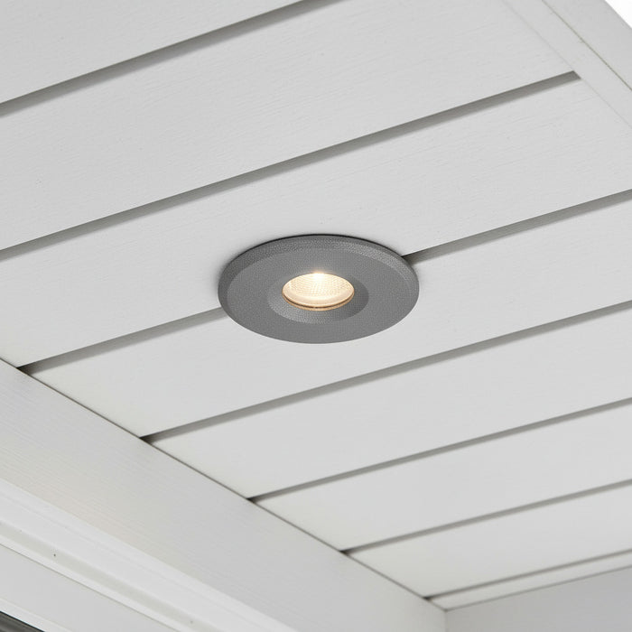grey small soffit light mounted in a white house soffit