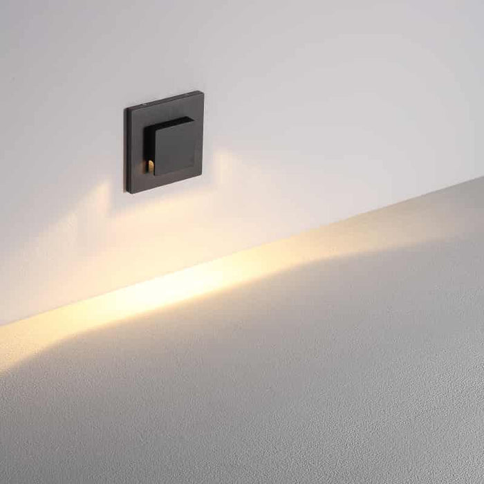black exterior stair lighting mounted on a white wall
