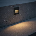 black stair step lighting installed into a concrete exterior step