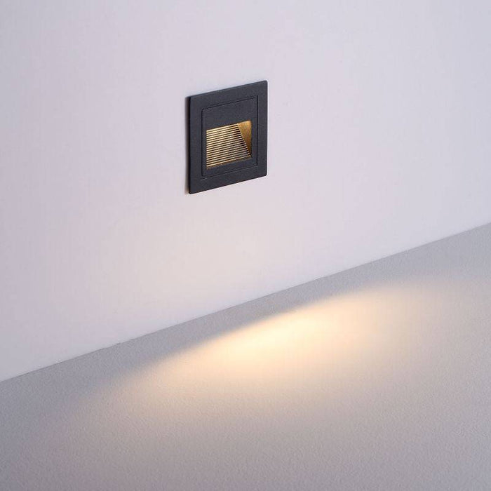 black stair step lighting installed on a white wall