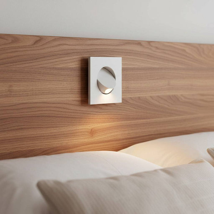 white recessed LED reading light for bed recessed into a wooden bed headboard in a minimailst bedroom