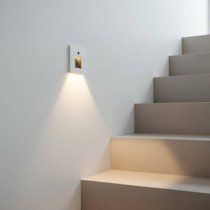 white LED stair light with motion sensor fitted in the wall next to some stairs indoors