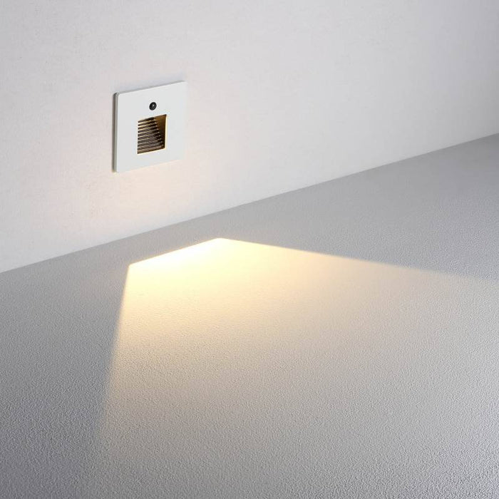 white LED stair light with motion sensor installed on a white wall