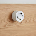 white adjustable bed lamp for reading mounted on a wooden bed headboard