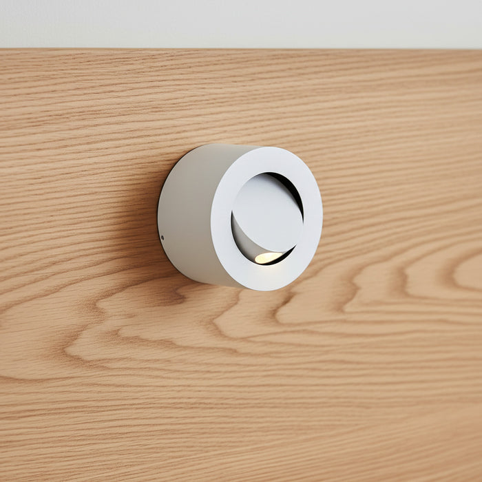 white adjustable bed lamp for reading mounted on a wooden bed headboard