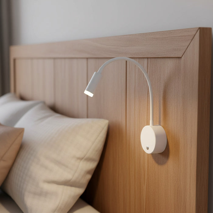 white dimmable bedroom reading light mounted on a wooden headboard