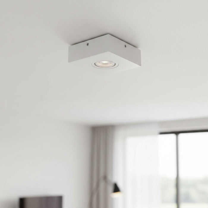 white low profile surface mount downlight installed on a white ceiling