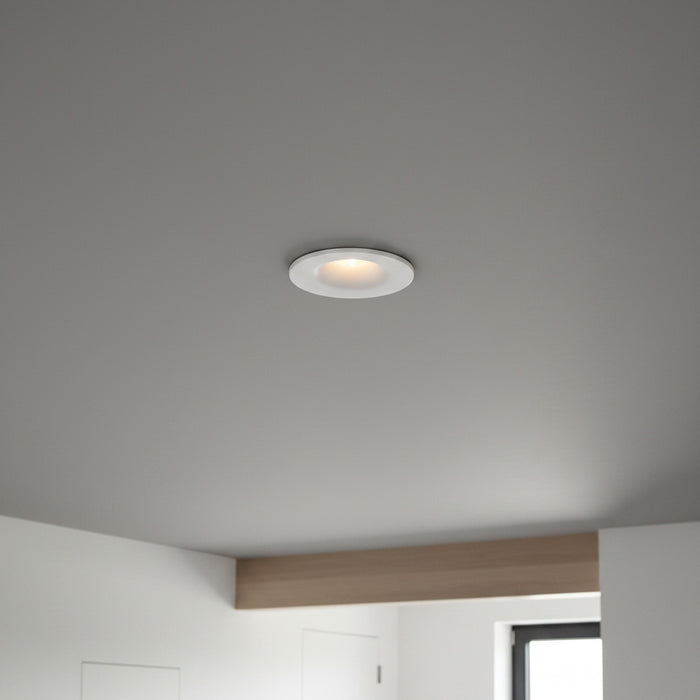 white small LED downlight fitting recessed into a grey ceiling in a modern home