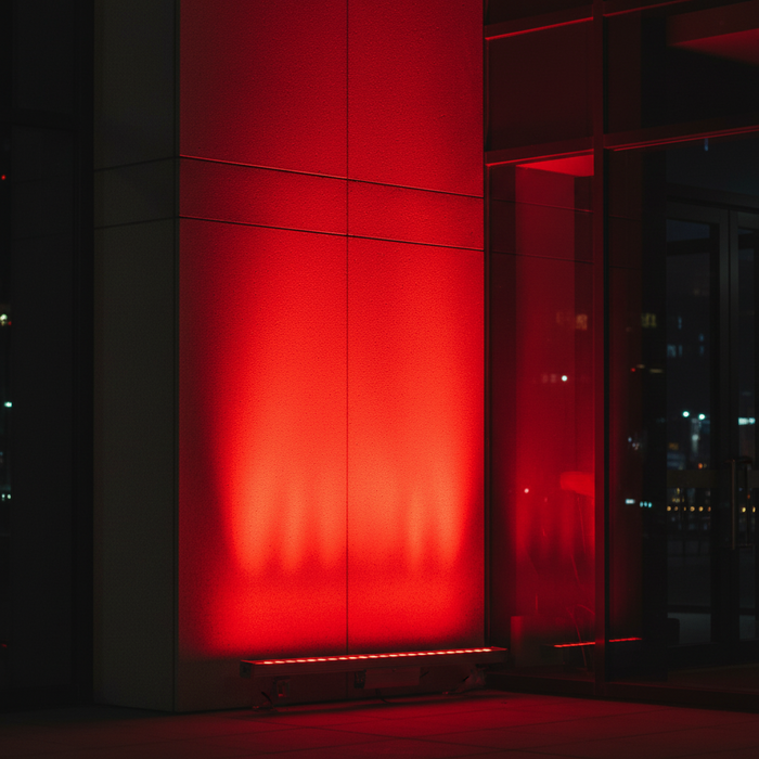 red linear wall grazer lighting up the outside of an office building