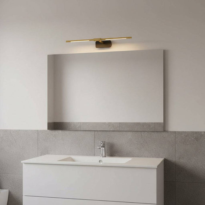 gold modern bathroom light over mirror in a modern bathroom