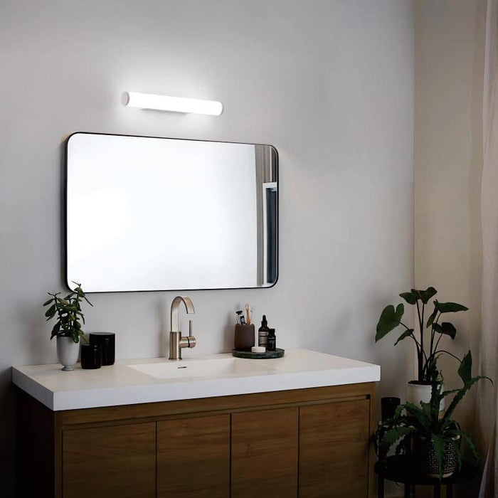 white bathroom mirror wall light mounted over the top of a bathroom mirror