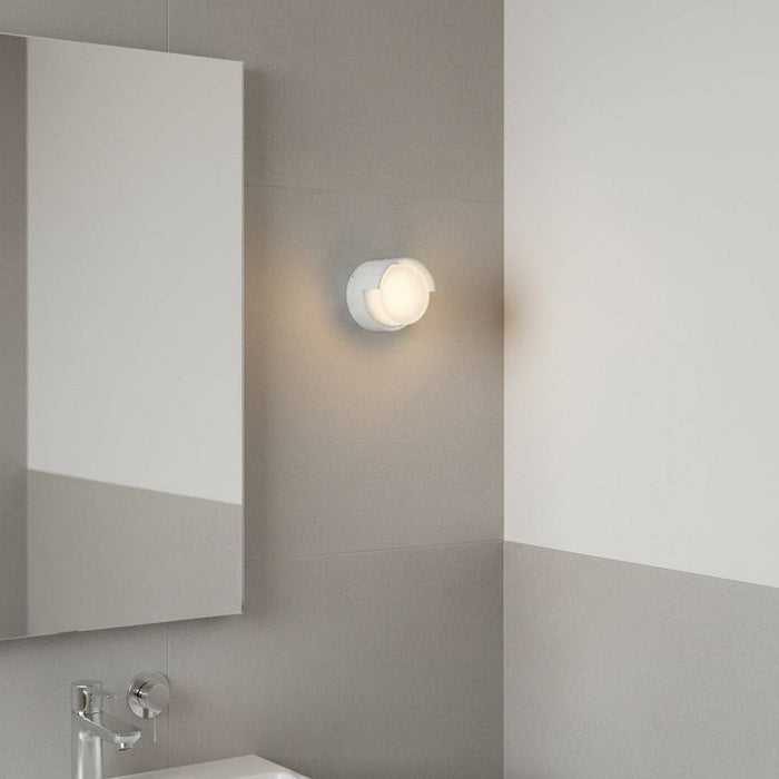 white IP65 bathroom wall light mounted in a modern bathroom next to the mirror