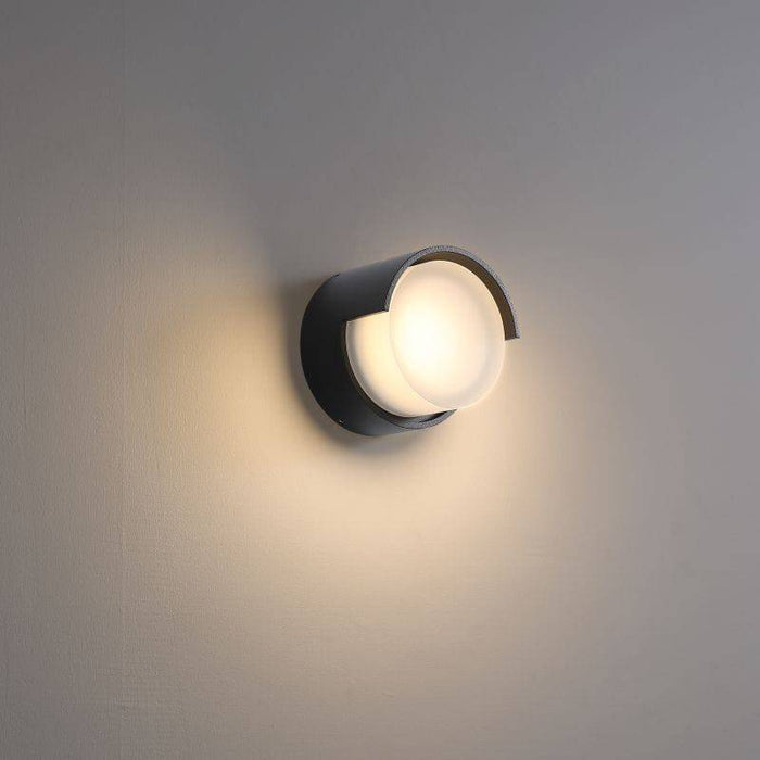 black outside wall lamp mounted on a white wall