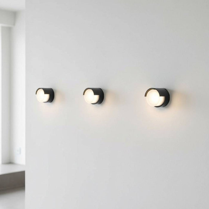 black outside wall lamp mounted on the white wall of a minimalist home