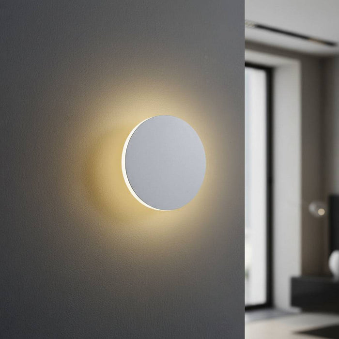White LED internal wall light on a grey wall looking like a moon in a modern home