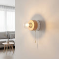 White finish interior LED wall light with pull cord on a plain wall in a modern home