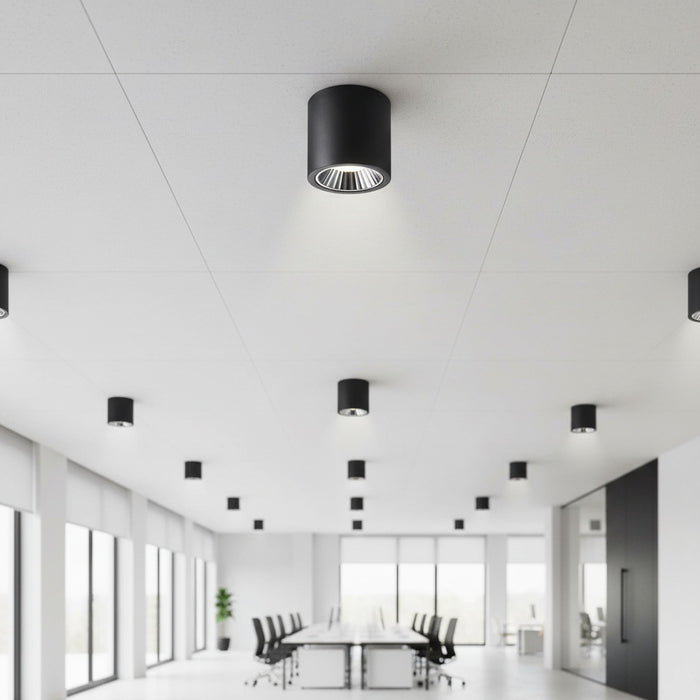 black large flush mount ceiling light mounted in an office boardroom