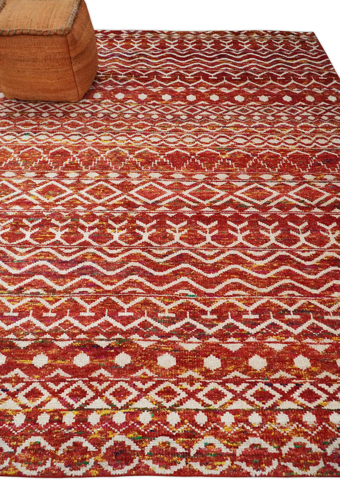 Hand-knotted area rug with geometric tribal trellis pattern in rust, gold, and white