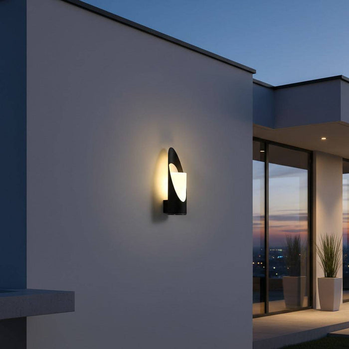 black outdoor wall light mounted on a white wall outside of a modern house
