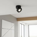 black adjustable surface mounted downlight on the ceiling of a modern home