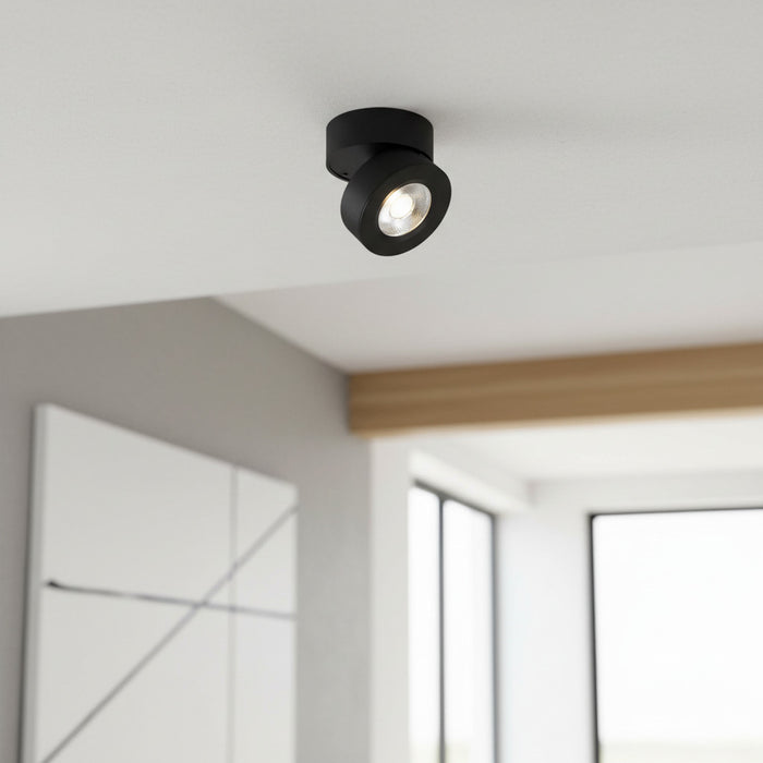 black adjustable surface mounted downlight on the ceiling of a modern home