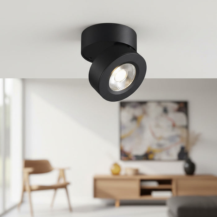 black adjustable surface mounted downlight installed on the ceiling in a house