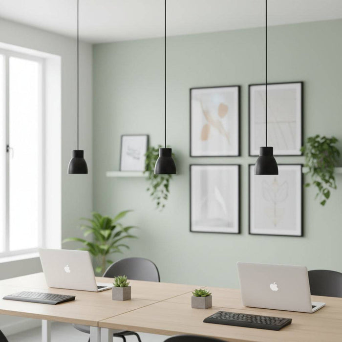 Black LED pendant light three above desks with laptops on them in a modern setting