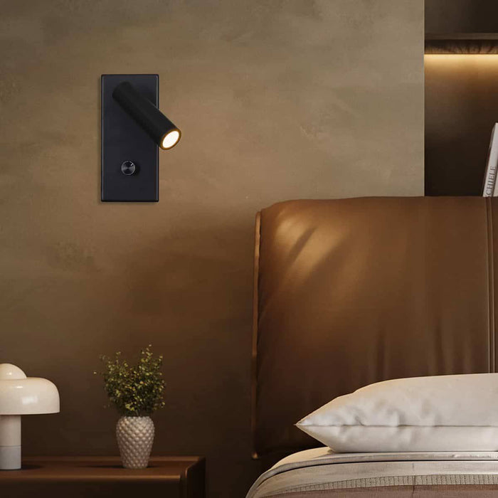 black dimmable reading light mounted on a textured wall next to the bed