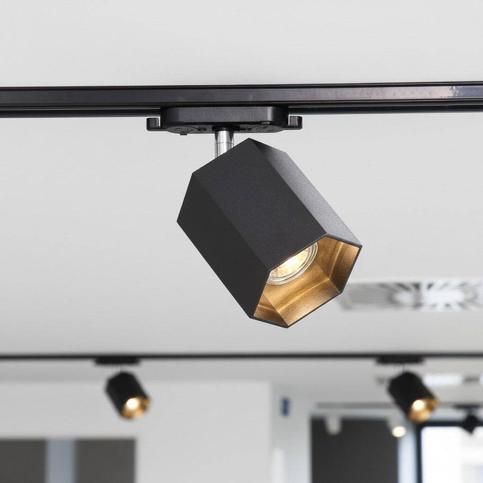 black LED track light mounted on the ceiling in a retail store