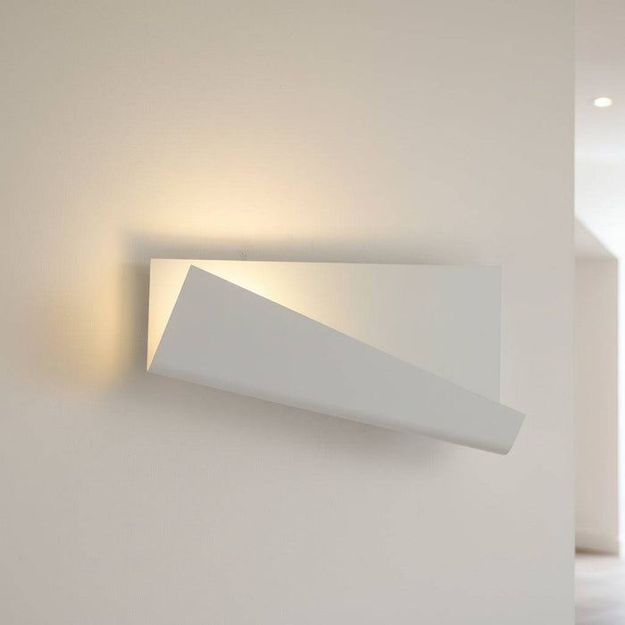 White modern wall sconce indoor on a cream background in a hallway
