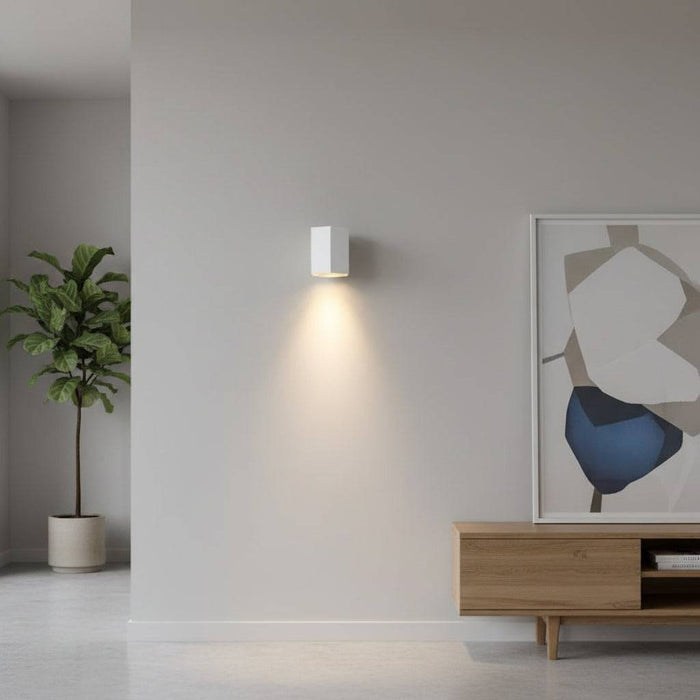 White indoor LED wall downlight on a light coloured wall in a lounge setting