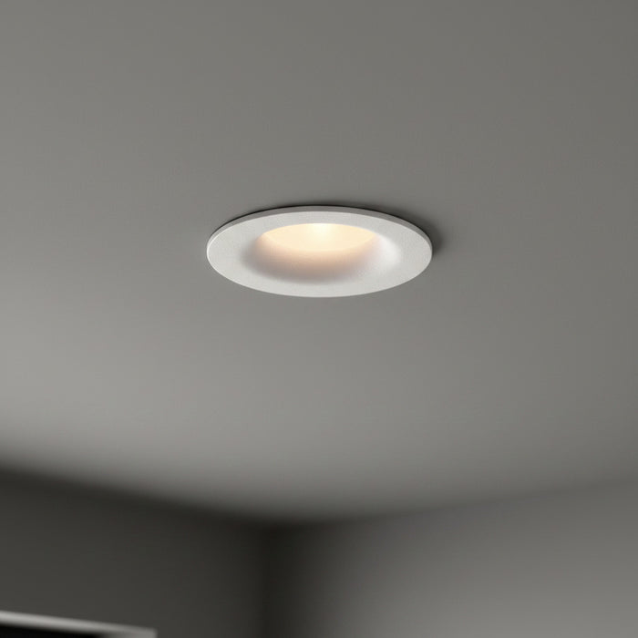 white LED ceiling downlight mounted in a dark grey home ceiling