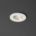 white recessed ceiling mounted downlight installed on a dark grey ceiling