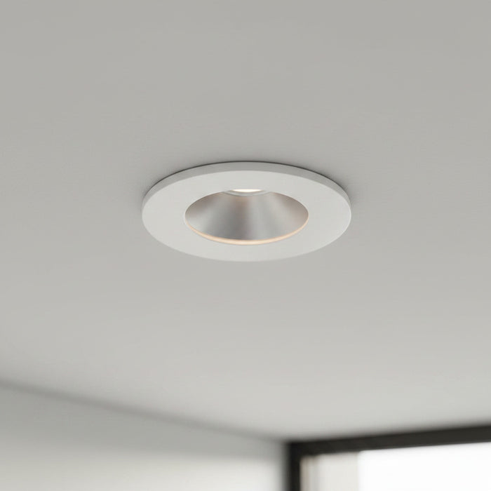 white recessed ceiling mounted downlight mounted on a grey ceiling