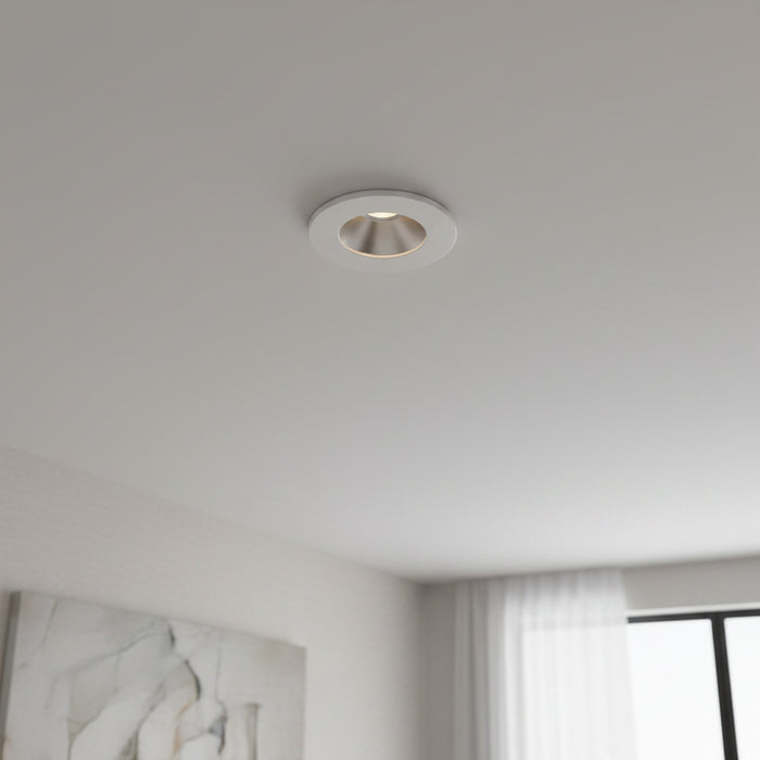 white recessed ceiling mounted downlight mounted on the ceiling in a modern home