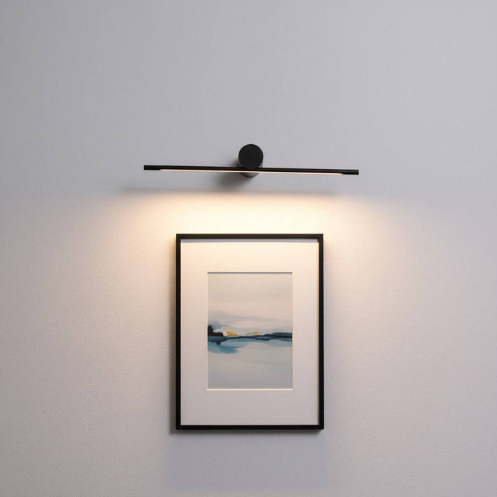 black picture light shown mounted on the wall over a picture