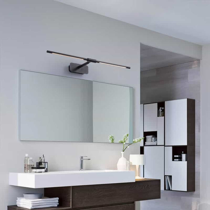 black bathroom sconce over mirror in a modern bathroom
