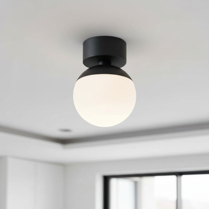 black semi flush ceiling light mounted on the ceiling in a modern kitchen