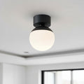 black semi flush ceiling light mounted on the ceiling in a modern kitchen