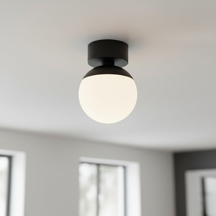black semi flush ceiling light mounted on the ceiling in a modern home