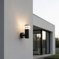 black outside wall sconce mounted on the outside wall of a modern house the wall is white