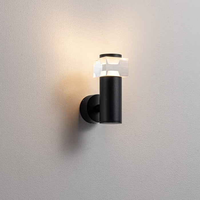 black outside wall sconce mounted on a white wall